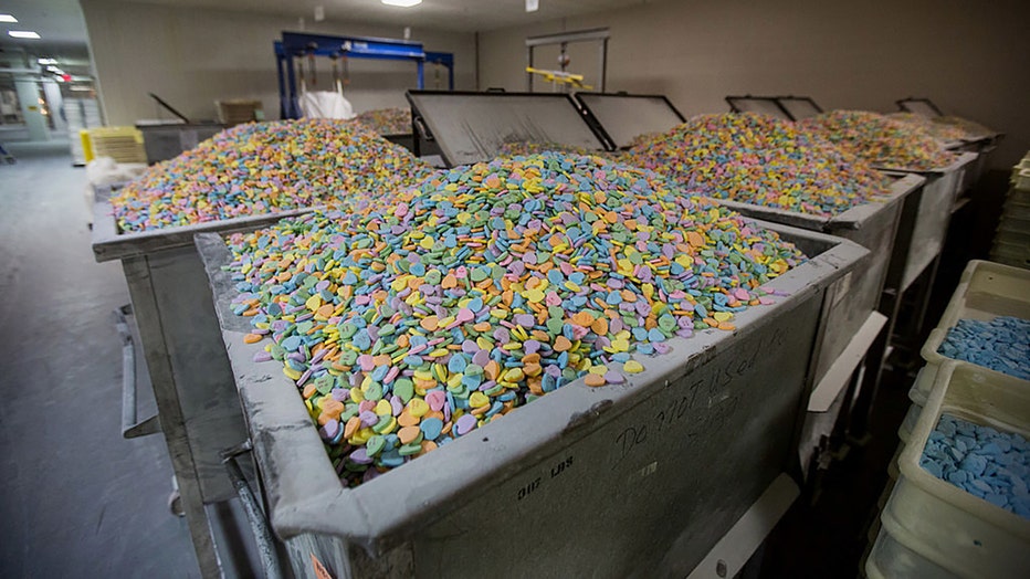 FILE - Containers of "Sweethearts" candy wait to be packaged at the New England Confectionery Co. (Necco) in Revere, Massachusetts, U.S., on Oct. 23, 2013. Photographer: Scott Eisen/Bloomberg via Getty Images