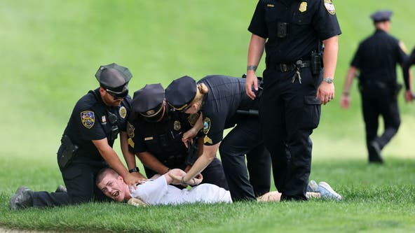 Protesters storm 18th green at Travelers Championship during crucial moment