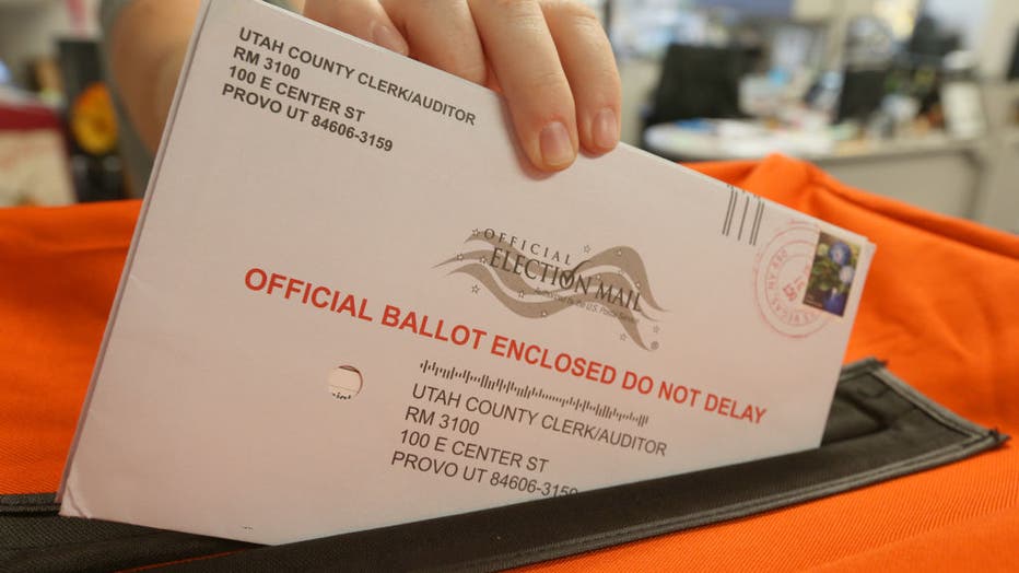 An employee at the Utah County Election office processes mail-in ballots for the midterm elections on November 6, 2018, in Provo, Utah.