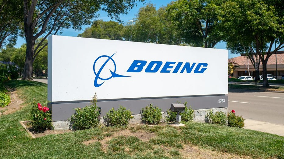 FILE - Sign with logo at entrance to office of aerospace company Boeing in Pleasanton, California, July 2, 2019. (Photo by Smith Collection/Gado/Getty Images)