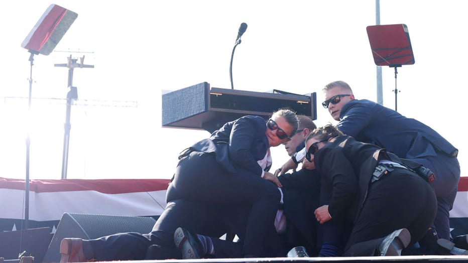 Republican presidential candidate former President Donald Trump is rushed offstage during a rally on July 13, 2024, in Butler, Pennsylvania. (Photo by Anna Moneymaker/Getty Images)