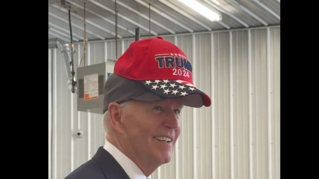 'No eating dogs and cats,' Biden jokes as he wears Trump 2024 hat