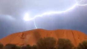 Uluru dazzles visitors with lightning show as park enters hottest season