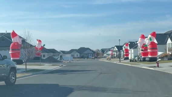 Watch: Giant Santa inflatables take over Utah neighborhood