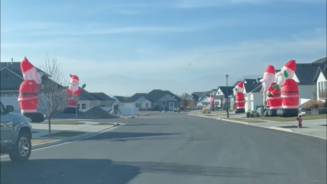 Watch: Giant Santa inflatables take over Utah neighborhood