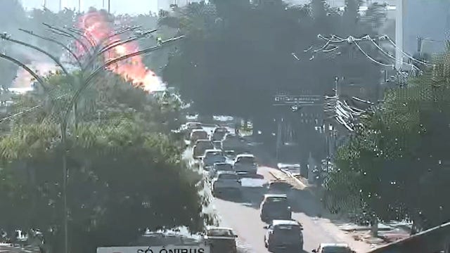 Video: Small plane crashes onto busy street, killing 2 people