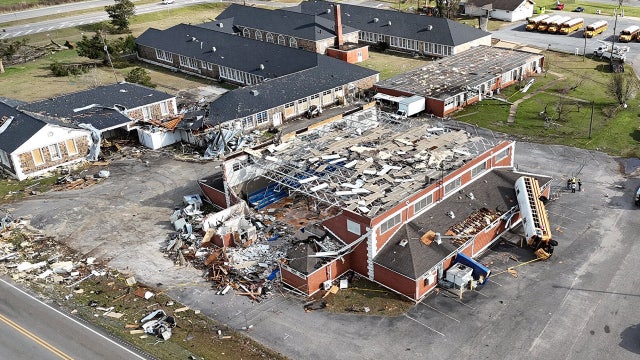 Video shows bus laying on Alabama high school gym after deadly tornado