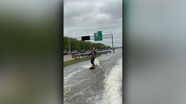 Viral video shows surfboarder's wild ride on flooded Arkansas interstate