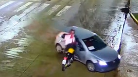 Video shows stunning motorcycle crash with rider flipping over car