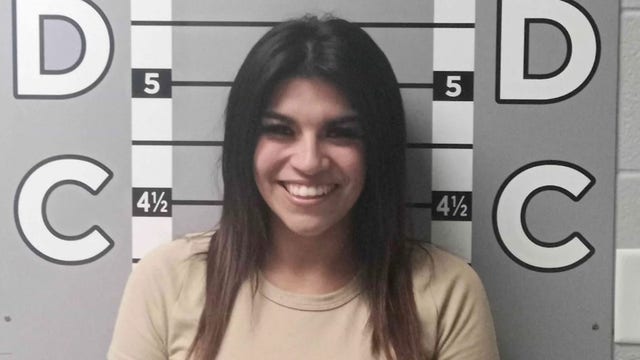 Woman's smiling mugshot goes viral after alleged $12K car vandalism spree against ex