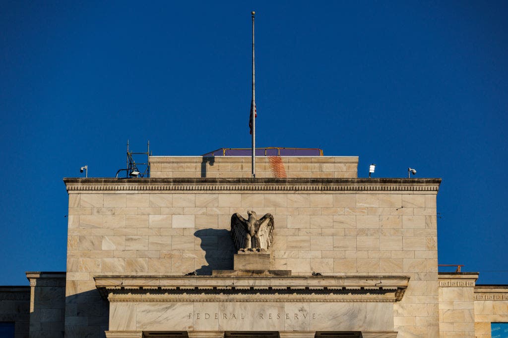 Fed cuts key interest rate, signals two more this year