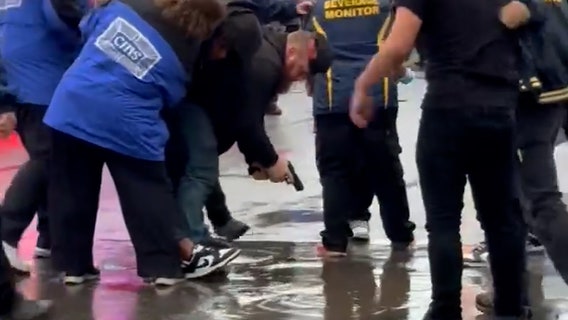 Watch: 'Heroic' man wrestles gun from brawling fairgoers