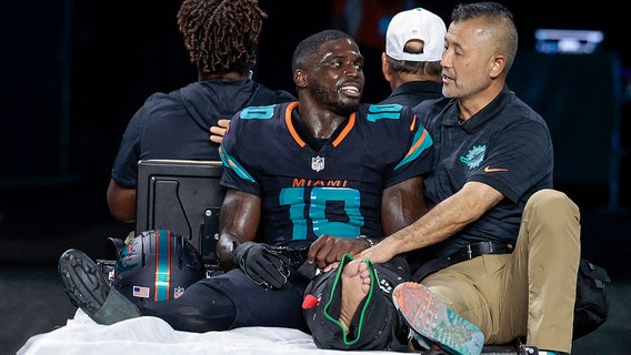 Dolphins star Tyreek Hill carted off field after gruesome knee injury on MNF