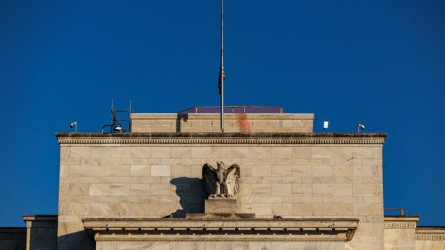 Fed cuts key interest rate, signals two more this year