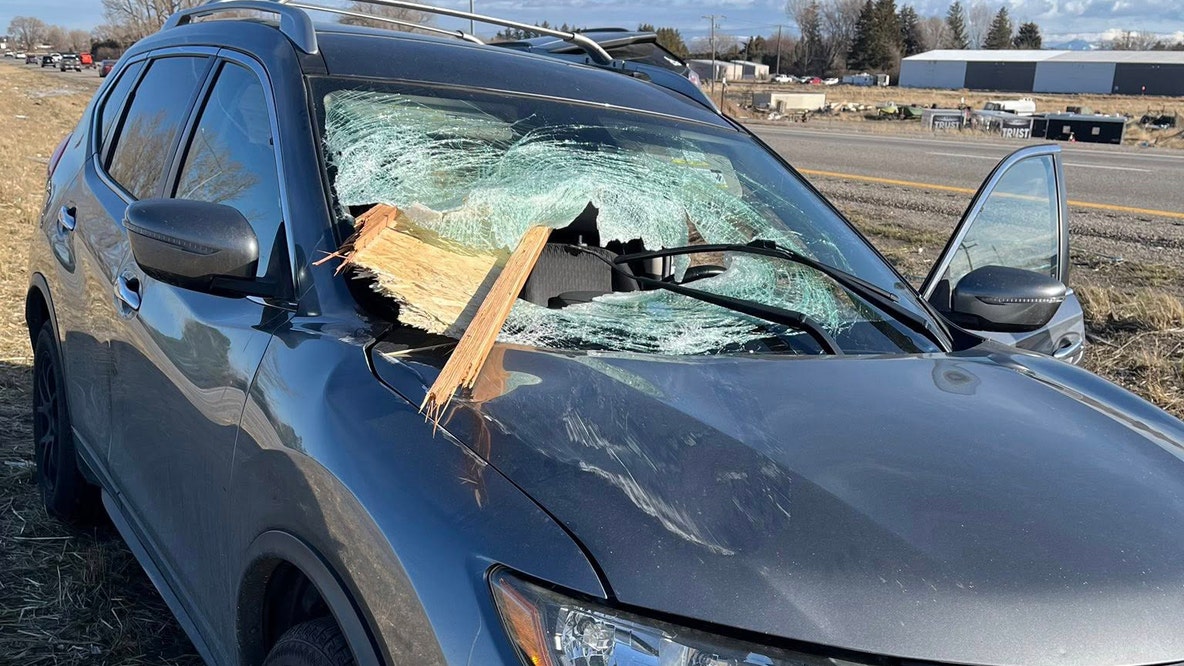 Wood crashes through car windshield, passengers escape injury