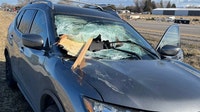 Wood crashes through car windshield, passengers escape injury