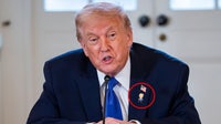Trump wears 'Happy Trump' pin on lapel, but says he's never happy