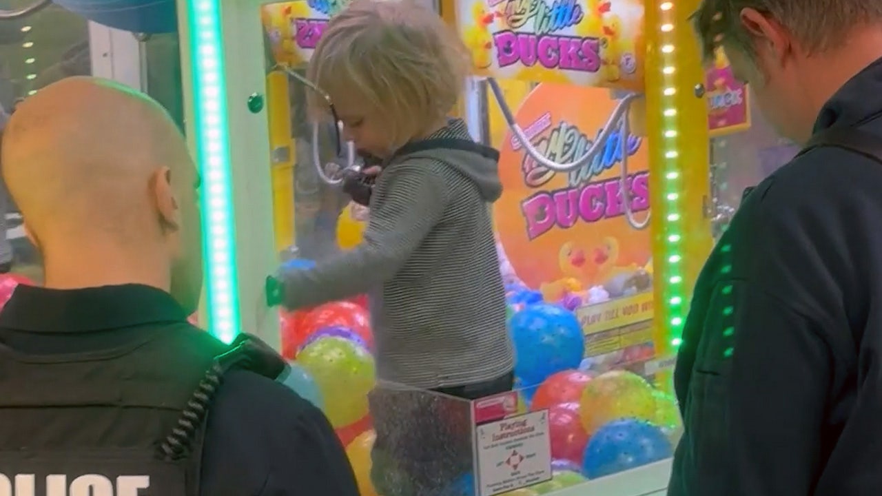 Watch: Smiling toddler gets stuck inside claw machine while parents aren't looking
