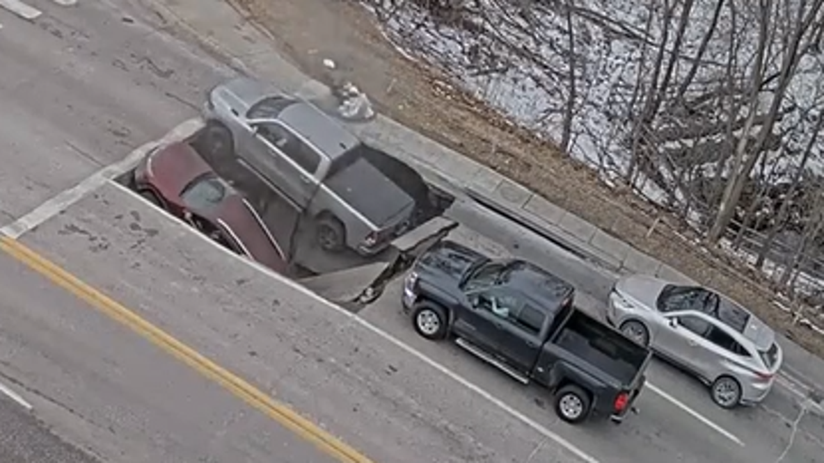 Watch: Sinkhole swallows two vehicles at Omaha intersection