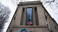 Banner featuring Trump displayed on DOJ headquarters