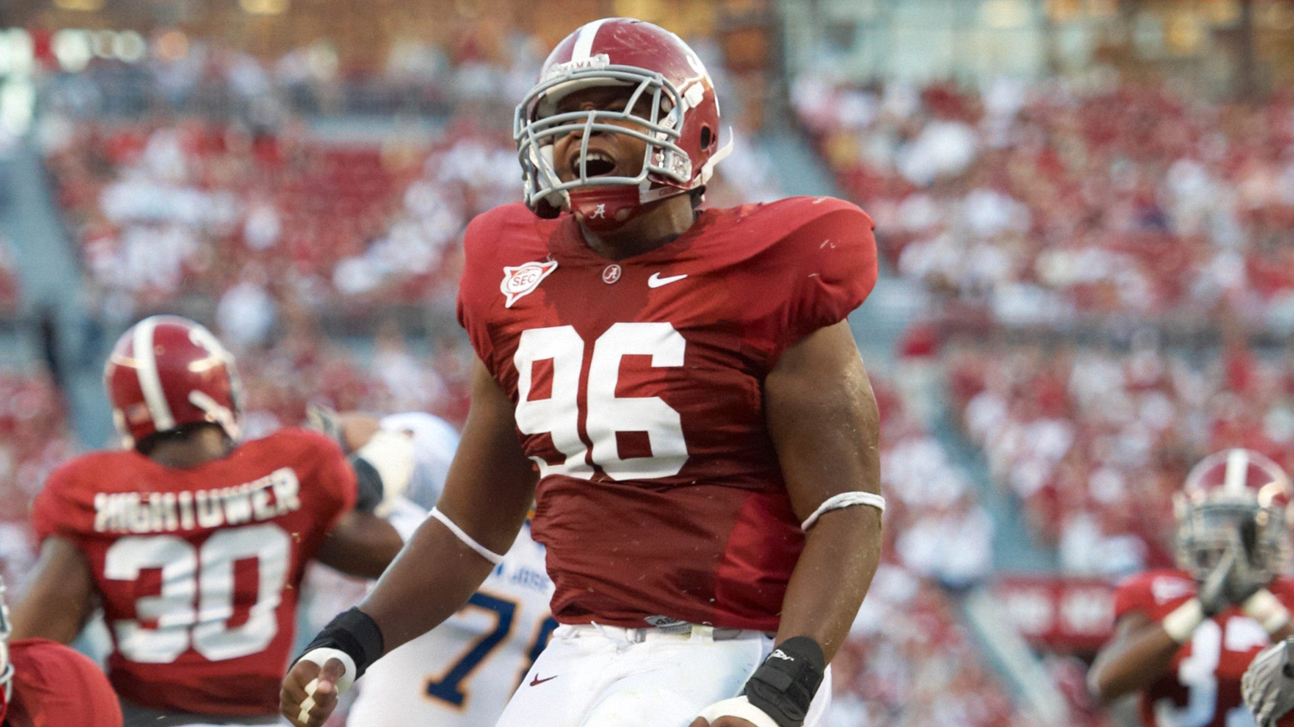 College football national champion who wore wigs in fraud scheme pleads guilty to charges