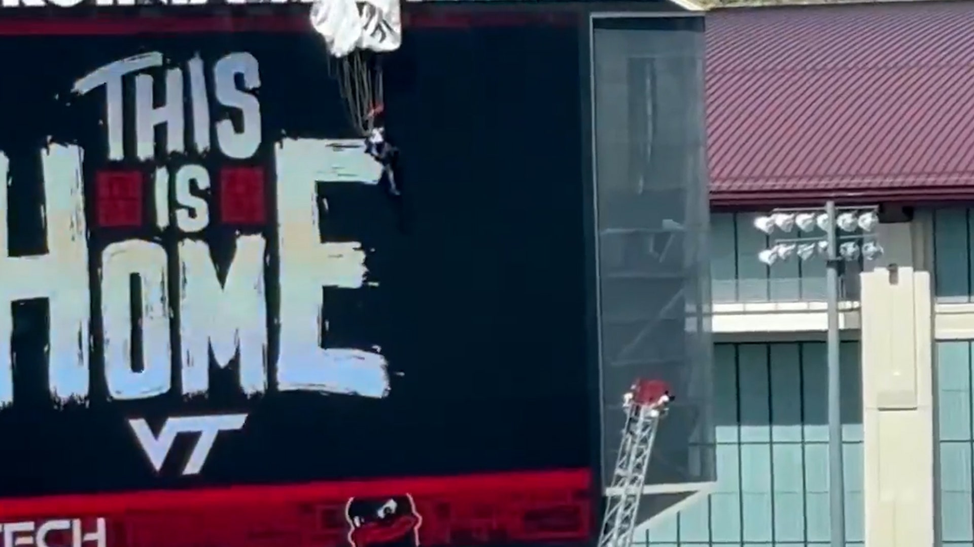 Parachutist carrying US flag slams into stadium scoreboard