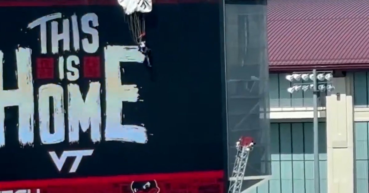 Parachutist carrying US flag slams into stadium scoreboard