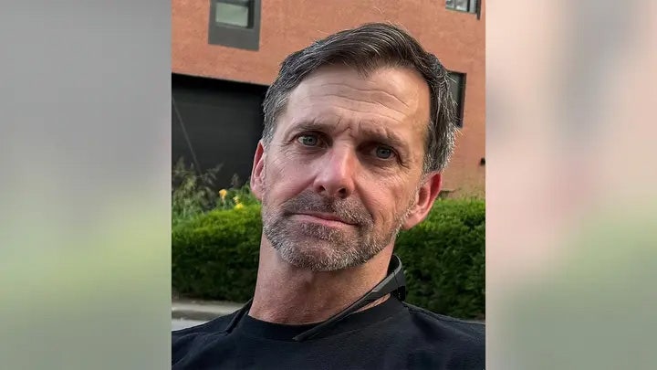 Military-trained fugitive accused of shooting wife eludes manhunt in rural woodlands