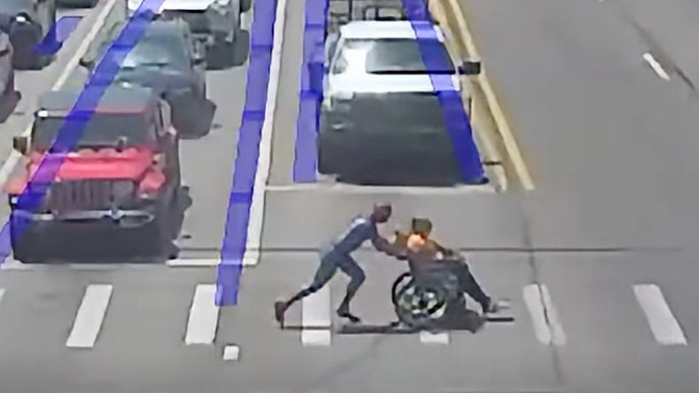 'Spider-Man' to the rescue - Helps man in wheelchair cross street