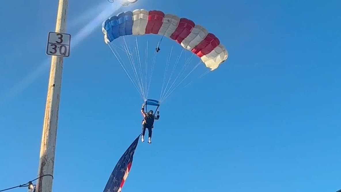 Watch: Star-spangled skydiver crash-lands into packed rodeo