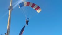 Watch: Star-spangled skydiver crash-lands into packed rodeo