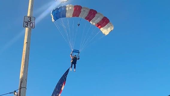 Watch: Star-spangled skydiver crash-lands into packed rodeo