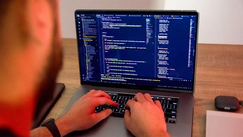 Hands typing on Macbook