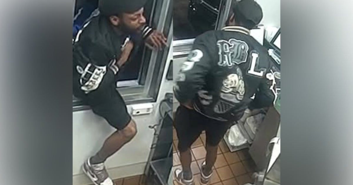 Watch: Fast food robbery suspect climbs through drive-thru window