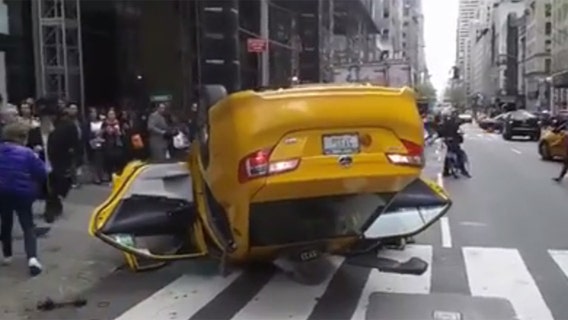 Taxi flips over in Midtown Manhattan