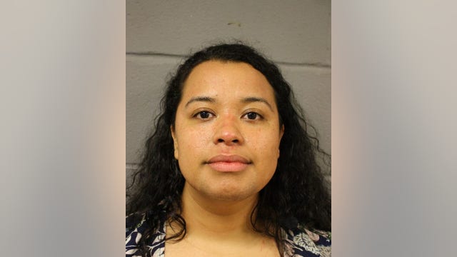 Police say woman tried to burn car with her children inside it
