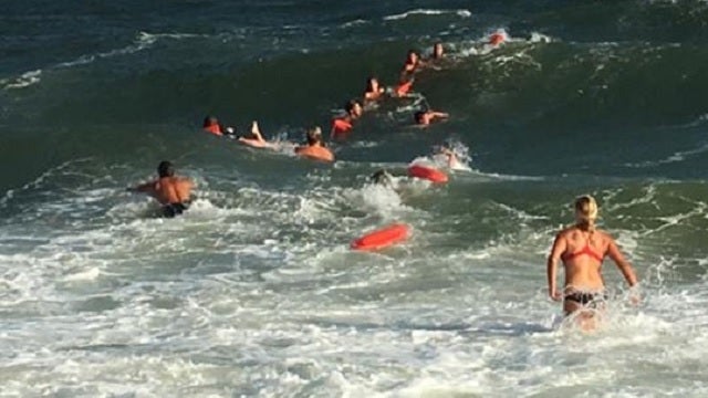 First responders form human chain to rescue struggling swimmer