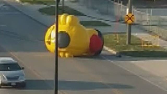On-the-loose giant inflatable duck rolls through Iowa street