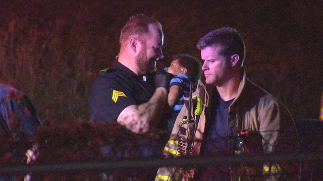 FOX 4 News photo of DPD officer comforting baby goes viral