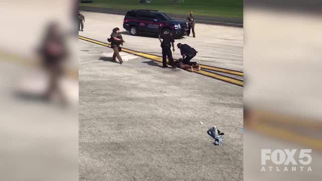 Officials: Half-dressed man runs out on airport taxiway