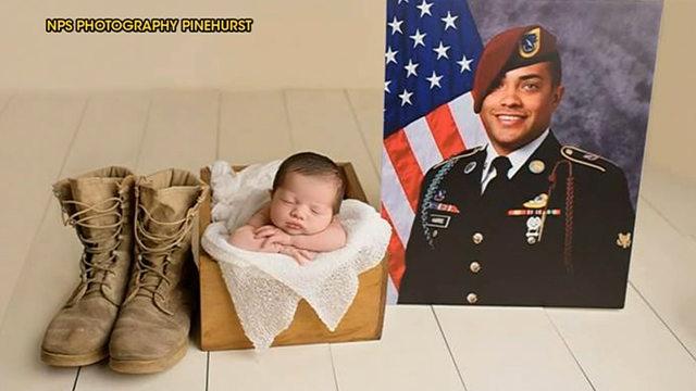 Newborn poses in late father's military uniform