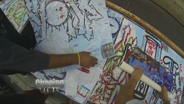 Sidewalk art exhibit uses maps as canvases