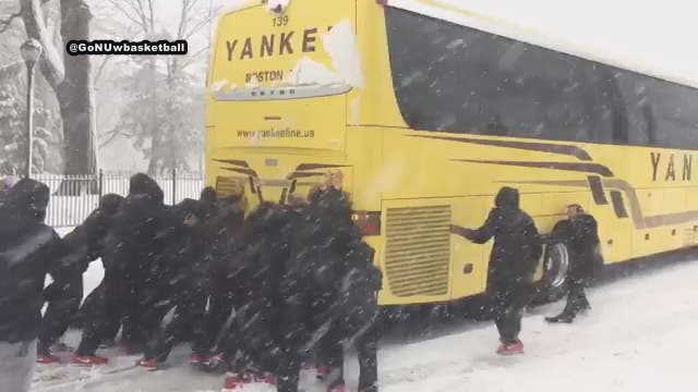 Northeastern University women's basketball team pushes bus out of the snow
