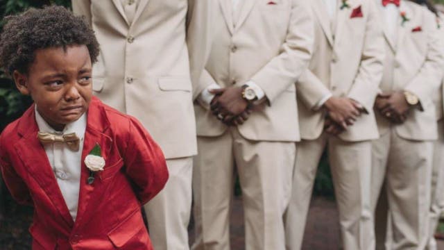 Little boy cries while watching mother walk down wedding aisle
