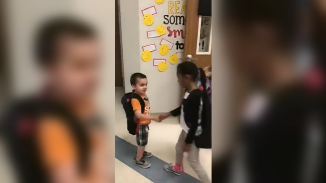 Kindergartners greet fellow students each day with handshakes, hugs