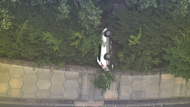 Car dangles off retaining wall following chase along I-20