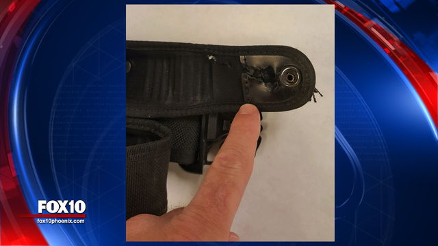 Tucson officer's belt stops bullet in 'way too close a call'
