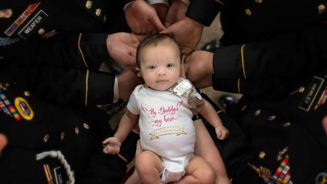 Combat unit of fallen hero meets newborn daughter in show of support