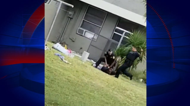 Video shows Miami officer kicking cuffed suspect in head