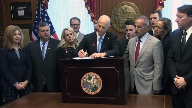 In break with NRA, Florida Gov. Scott signs a compromise gun bill written after a school shooting